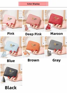 Detail of leaf pattern and bunny charm on colorful small zip wallets for women