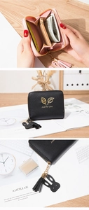 Detail of compact zip wallet showing card slots, gold leaf logo and tassel charm