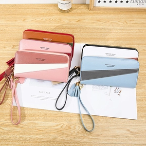 Women's long patchwork wallet with zipper closure, wristlet strap and tassel charms