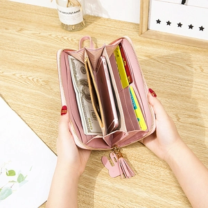 Women's pink long wallet with tassel and cactus charm showing spacious inner compartments
