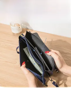 Detail view of the interior compartment featuring card slots and a mobile phone holder