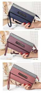 Detail view of lychee texture crossbody bags with black and white striped flap and metal chain