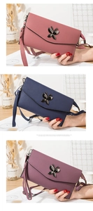 Detail of cross-body bags with butterfly metal clasp in pink, navy, and purple colors