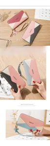 Detailed view of women long zip wallet with color blocking, tassels, and a wrist strap