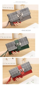 Detail of checkered long clutch wallet with metallic bow buckle and wrist strap