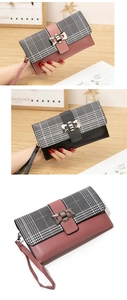Detail of long plaid wallet with leather stitching, bow metal buckle and wrist strap