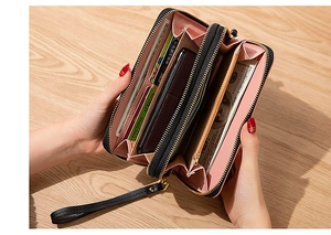 Detail of the multi-compartment interior showing card slots and pink lining of the wallet