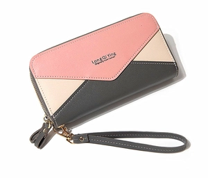 Detail of three-color patchwork faux leather wallet with gold zipper and wrist strap