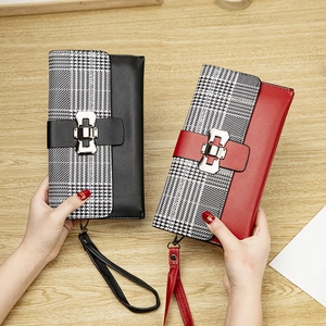 Detail of checkered long wallet with metal buckle and detachable wrist strap