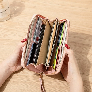 Pink long zip wallet for women featuring multiple compartments and phone storage capacity