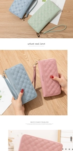 Detail of long PU leather wallet with crown pattern, quilted stitching and gold zipper