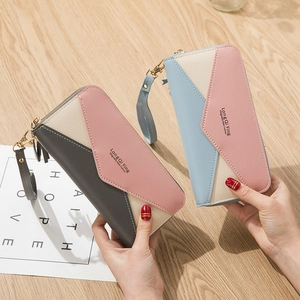 Women's long zipper wallet featuring a contrast color patchwork design and wristlet strap