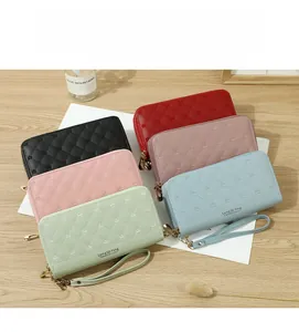 Detailed macro view of quilted PU leather wallets with crown embroidery in various colors