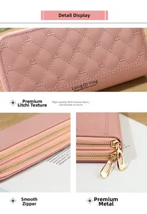 Detail of pink quilted wallet with lychee texture, crown stitching and gold zippers