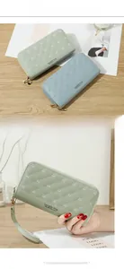 Detail of quilted leather long wallet with crown accent and dual zipper closure