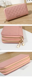 Detail view of pink quilted long wallet with double zipper and crown embroidery