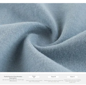 Detailed close-up of light blue ribbed knit cotton fabric with textile safety standards