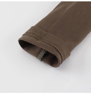 Detailed close-up of high-quality knitted cotton cuff with durable green reinforced stitching