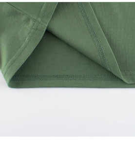 Detailed close-up of double-stitched hem on dark green cotton long-sleeve kids T-shirt