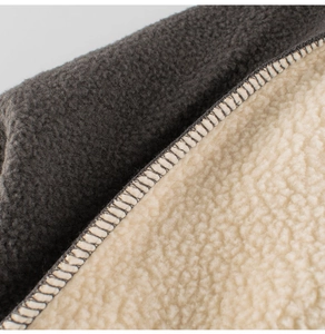 Macro view of gray sweatshirt fabric with warm white fleece lining and neat stitching