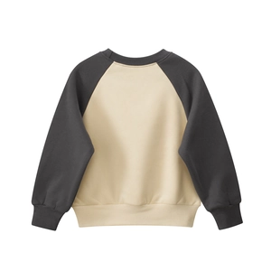 Detail of raglan sleeves and ribbed knit cuffs on kids' fleece crewneck sweatshirt