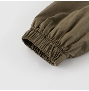 Detail of elastic cuffs and windproof fabric texture on boy's woven casual jacket