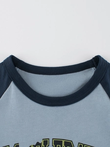 Close-up of boys' raglan long sleeve T-shirt featuring navy and light grey crew neck