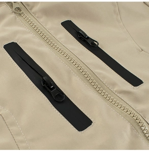 Detail view of khaki toddler jacket featuring smooth zip closure and durable fabric texture