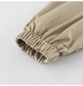 Detailed close-up of khaki children's jacket elastic cuffs and twill cotton fabric