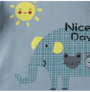 Close-up of blue cotton knit fabric with a colorful elephant and sun cartoon print