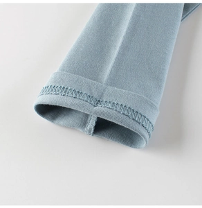 Detailed macro view of the light blue cotton cuff with precise double-needle stitching
