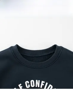 Detail of navy fleece sweatshirt showing the ribbed crew neck and white text printing