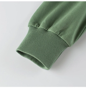 Macro shot of green ribbed cuffs on children's knitted cotton long-sleeved sweatshirt