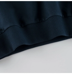 Close-up detail of navy blue ribbed knit hem on high-quality cotton children's clothing