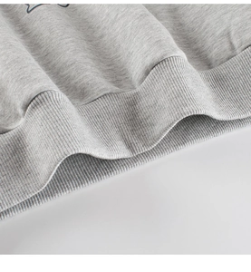 Detailed close-up of the heather grey ribbed hem on the toddler fleece sweatshirt