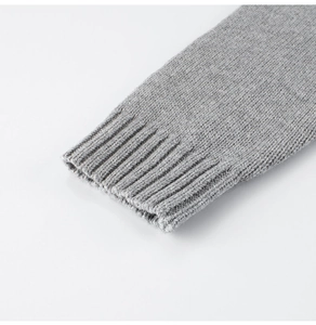 Close-up of grey ribbed knit cuffs on kids sweater jacket with soft wool texture