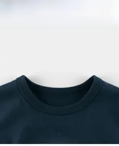 Detail of the navy blue cotton t-shirt collar featuring a durable ribbed crew neck design