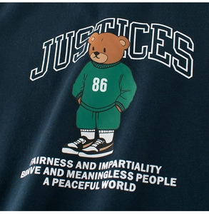 Detail view of cartoon bear graphic on navy cotton T-shirt showing print quality