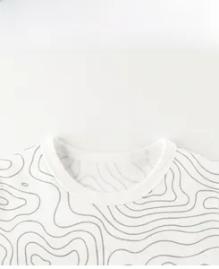 Close-up of the fine stitching and ribbing on a white T-shirt crew neck with grey waves