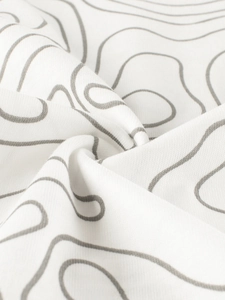 Close-up of boys white cotton T-shirt fabric with grey topographic pattern print