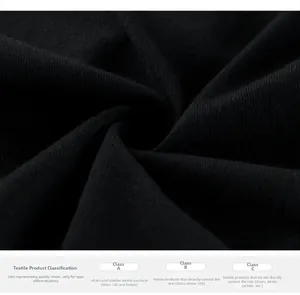 Close-up of soft black knit fabric showing premium texture and safety certification label