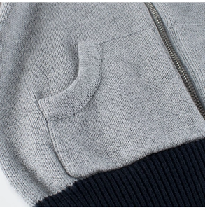 Dettaglio di maglione in maglia per bambini con cerniera e tasca laterale