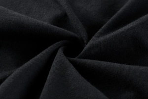 Macro detail of soft black knitted fabric texture showing premium cotton elasticity