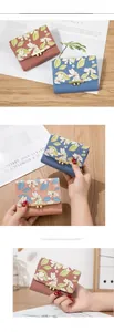 Detailed view of floral mini bifold wallets with elegant gold flower metal hardware