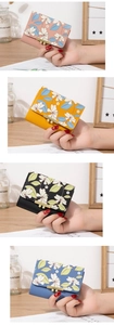 Detail of mini floral wallet with golden metal buckle and cute flower print on PU leather