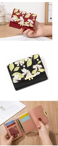 Short floral wallet detail showing trifold leather layers, card slots, and gold metal clasp