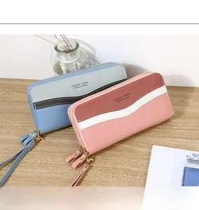 Close-up of double zipper women's long wallets with wrist straps and lychee pattern