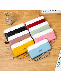 Detailed close-up of long PU leather wallets with wave edge trim and wrist strap