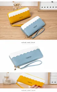 Close-up of PU leather long wallet featuring wavy edges and functional wrist strap