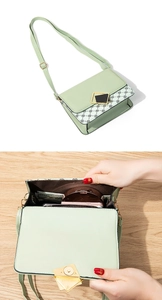 Detail view showing internal storage for phone and cash in green crossbody bag